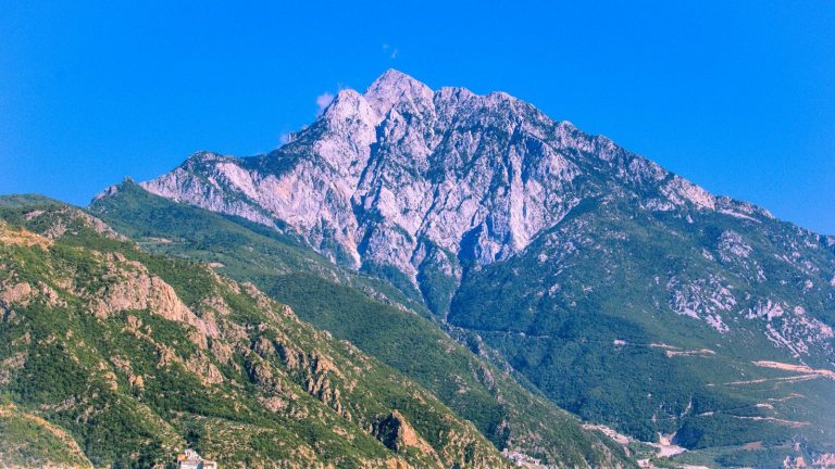 a mountain range with a boat in the water